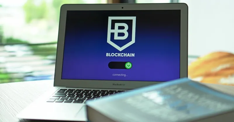 Laptop with blockchain application interface connecting. Ideal for tech and crypto themes.